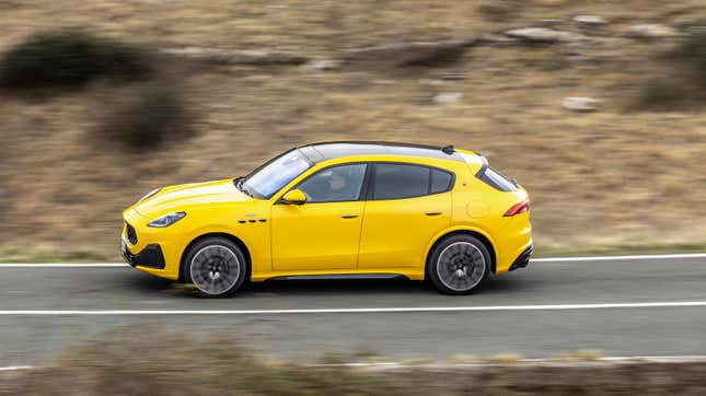 The yellow 2023 Maserati Grecale Trofeo drives along a mountain road.